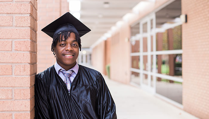 Graduate Dennis Cervantez outside the downtown FSJC Advanced Technology Center