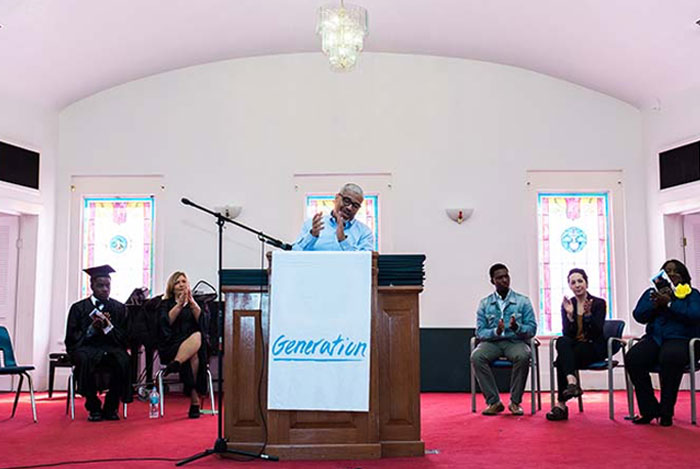 George Maxey, executive director of New Town Success Zone at Edward Waters College, addresses Generation graduates, families, and community partners